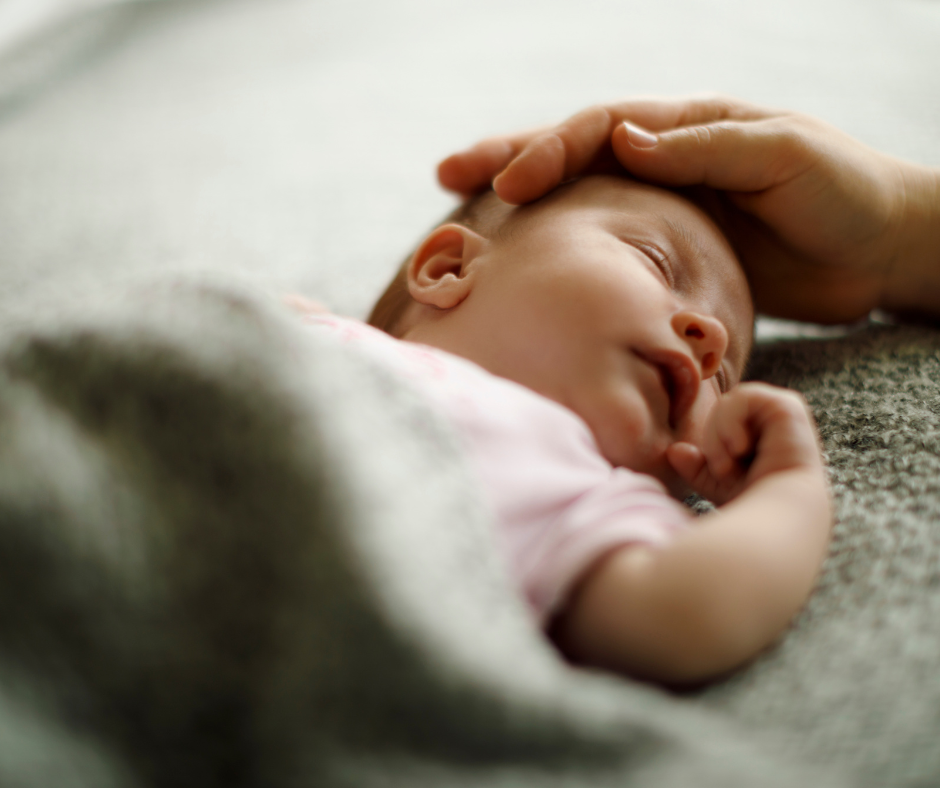 Newborn baby sleeping with parent gently touching their head - Arlie Hastings Lactation Consultant. Breastfeeding support home visits in Gold Coast, Tamborine, Logan and Redlands. Telehealth video chat consultations.