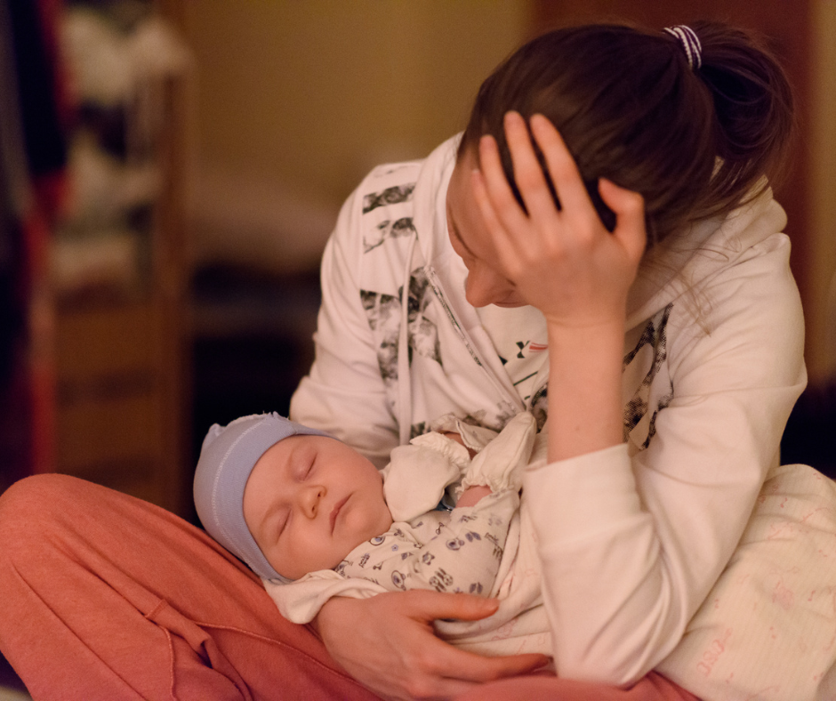 Tired mum with baby sleeping in her arms - Arlie Hastings Lactation Consultant. Breastfeeding support home visits in Gold Coast, Tamborine, Logan and Redlands. Telehealth video chat consultations.