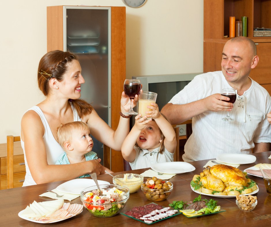 alcohol and breastfeeding - mother drinking a glass of wine at dinner with her family - Arlie Hastings Lactation Consultant. Breastfeeding support home visits in Gold Coast, Tamborine, Logan and Redlands. Telehealth video chat consultations.