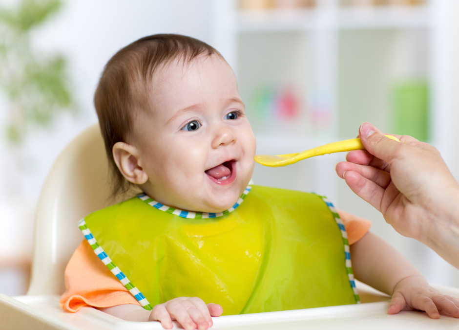 introducing solids while breastfeeding - mother breastfeeding her baby while looking frustrated - Arlie Hastings Lactation Consultant. Breastfeeding support home visits in Gold Coast, Tamborine, Logan and Redlands. Telehealth video chat consultations.